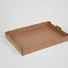 A shallow, empty cardboard tray with low sides on a white background.