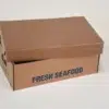 Close-up of a cardboard box labeled "FRESH SEAFOOD" filled with seafood