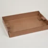 Shallow brown cardboard tray with folded sides.