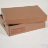 Closed cardboard box with printed handling instructions on the side.