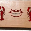 Cardboard box with red lobster illustrations and 'Your Brand Here!' text.