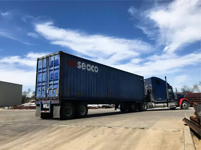 a blue truck with a trailer - SCHC packaging & logistic solution.