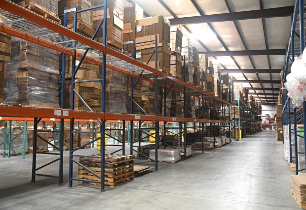 Organized warehouse with labeled shelves and boxes, showcasing efficient inventory management.